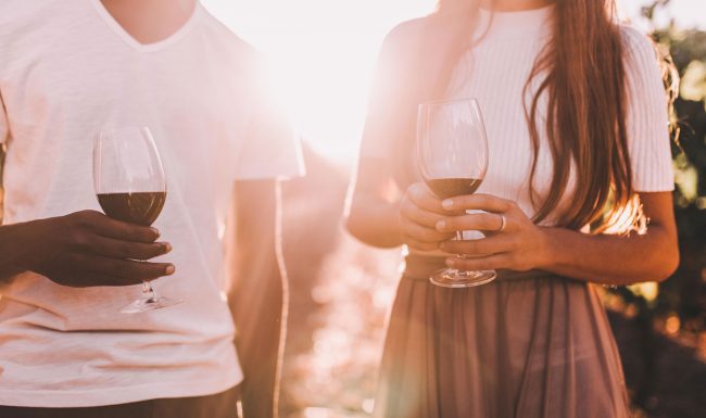Two people holding wine glasses