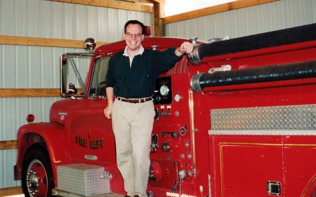 Man standing on a firetruck